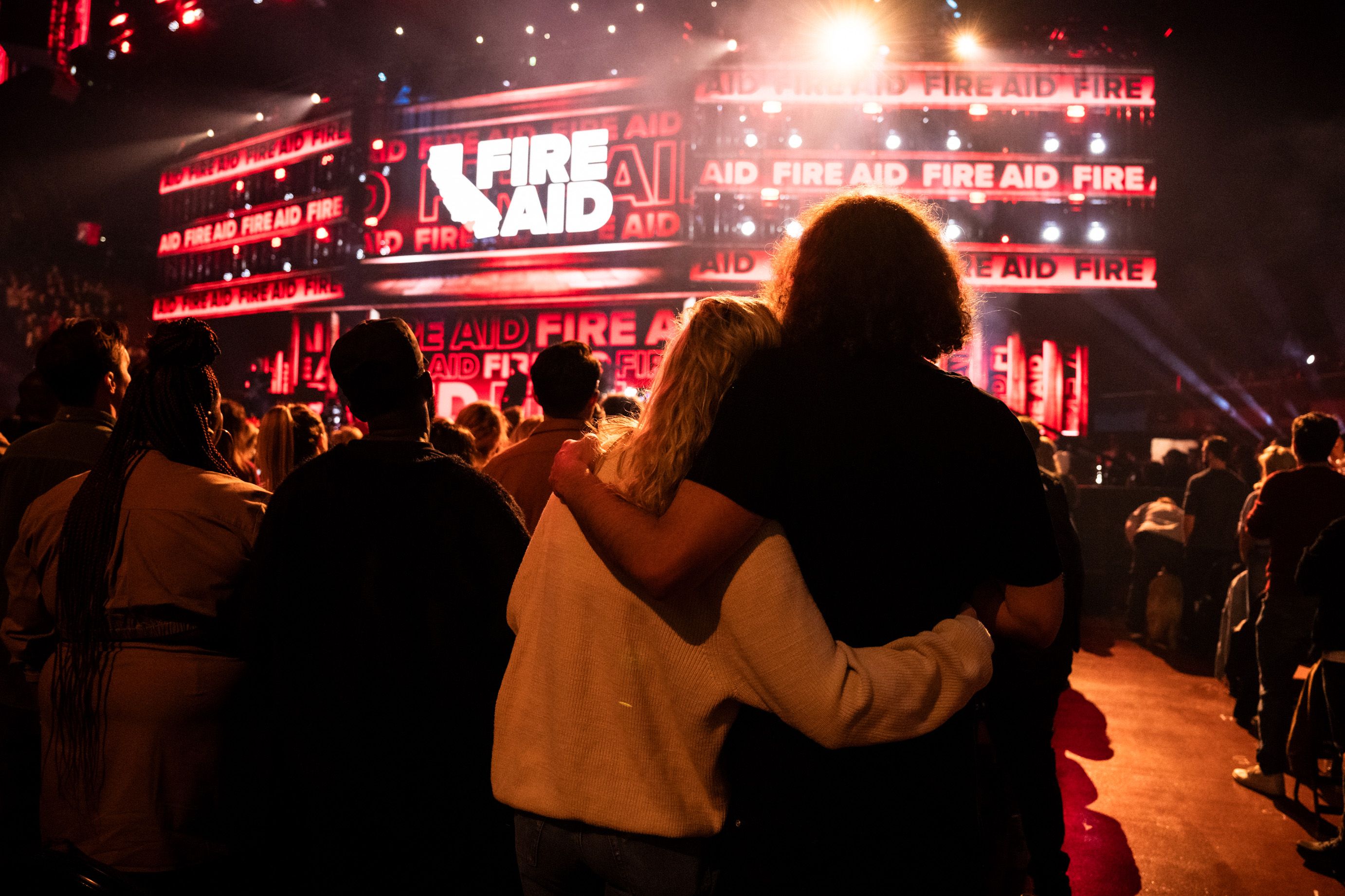 People hugging at FireAid Benefit Concert